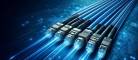 DALL·E 2024-05-22 15.27.42 - A realistic and cool-looking image of multiple fiber optic cables with connectors, displayed horizontally against a techy blue background. Extend the